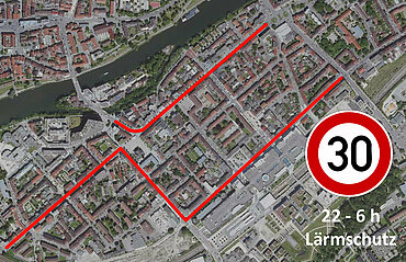 Luftbild von der Neu-Ulmer Innenstadt mit einem Tempo 30-Schild und dem Text "22 bis 6 Uhr Lärmschutz" sowie den rot markierten betroffenen Straßenbereichen (wie im Text beschrieben)