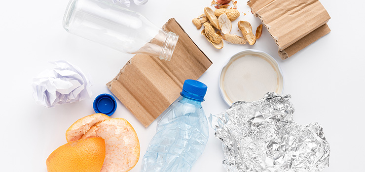 Verschiedene Müllsorten wie Glas, Pappe und Plastik
