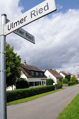Straßenschild mit Ulmer Ried und Wohngebiet